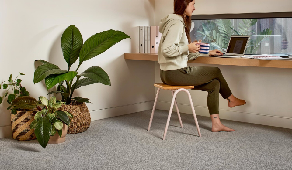 Woman working from home in carpeted office